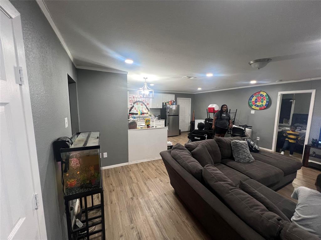 1722 Proctor Street Grand Prairie, TX 75051 - Photo 32 of 39 Living room featuring light wood-type flooring, ornamental molding, and recessed lighting