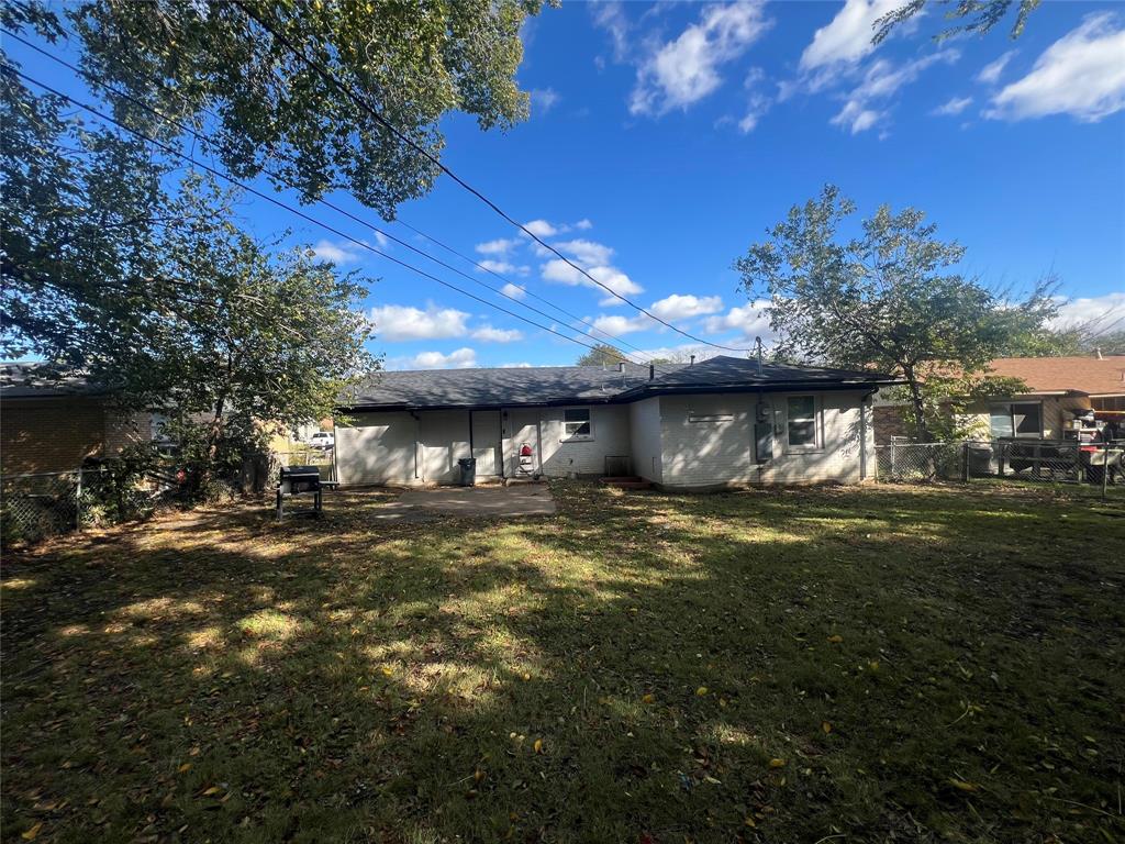 1722 Proctor Street Grand Prairie, TX 75051 - Photo 39 of 39 Rear view of house with a shingled roof and a patio area