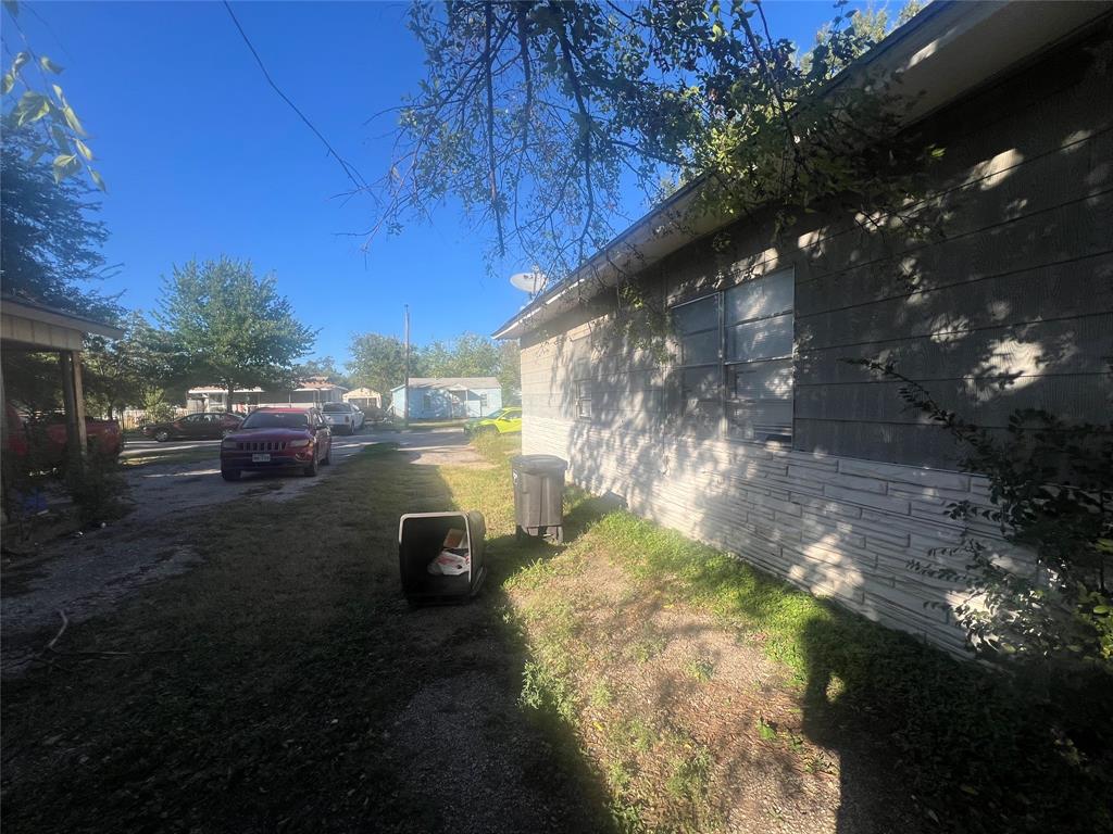 1722 Proctor Street Grand Prairie, TX 75051 - Photo 8 of 39 View of home's exterior with a yard