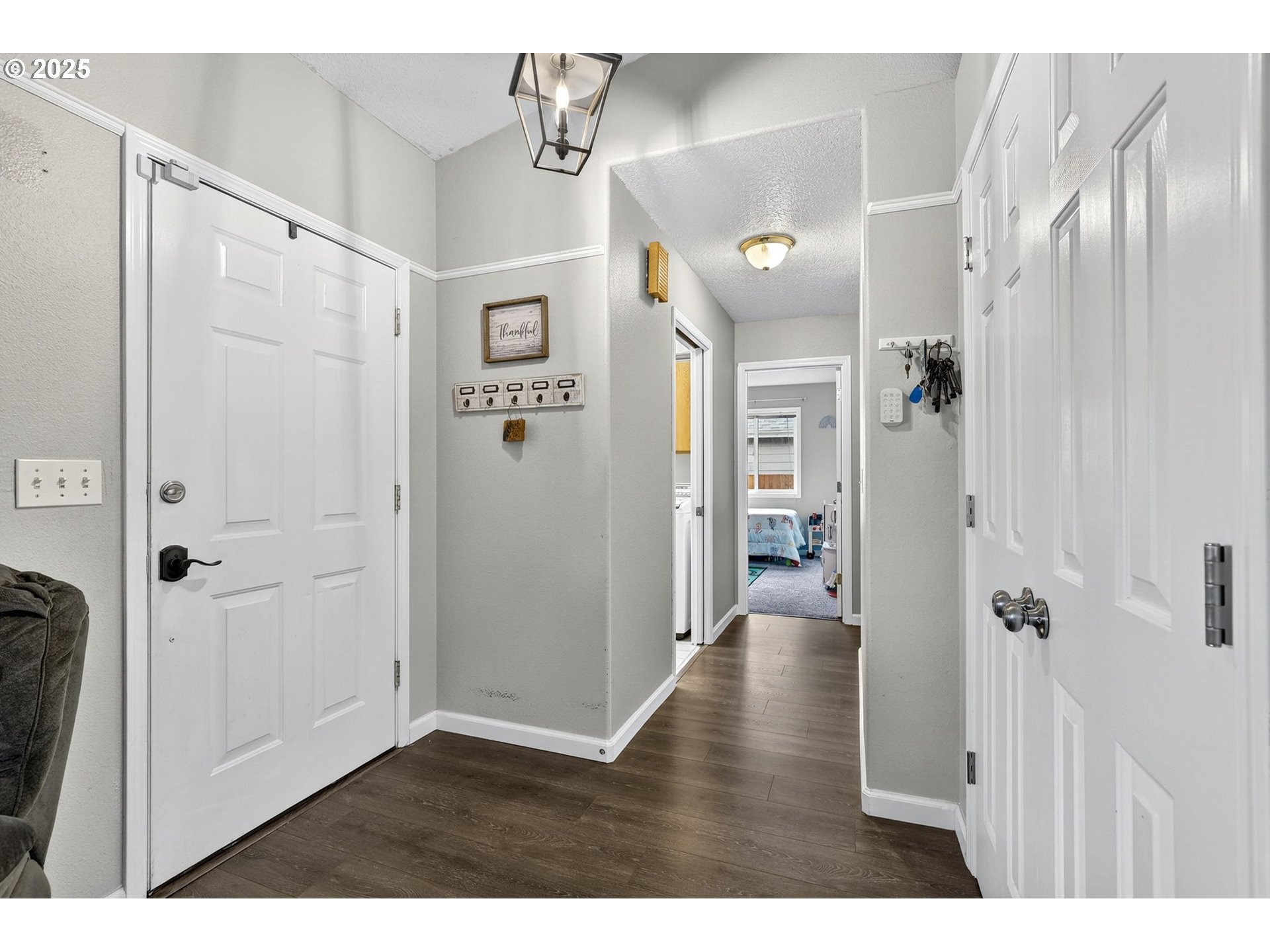 3915 Southeast 14th Street Gresham, OR 97080 - Photo 11 of 46 a view of a hallway with wooden floor and a livingroom