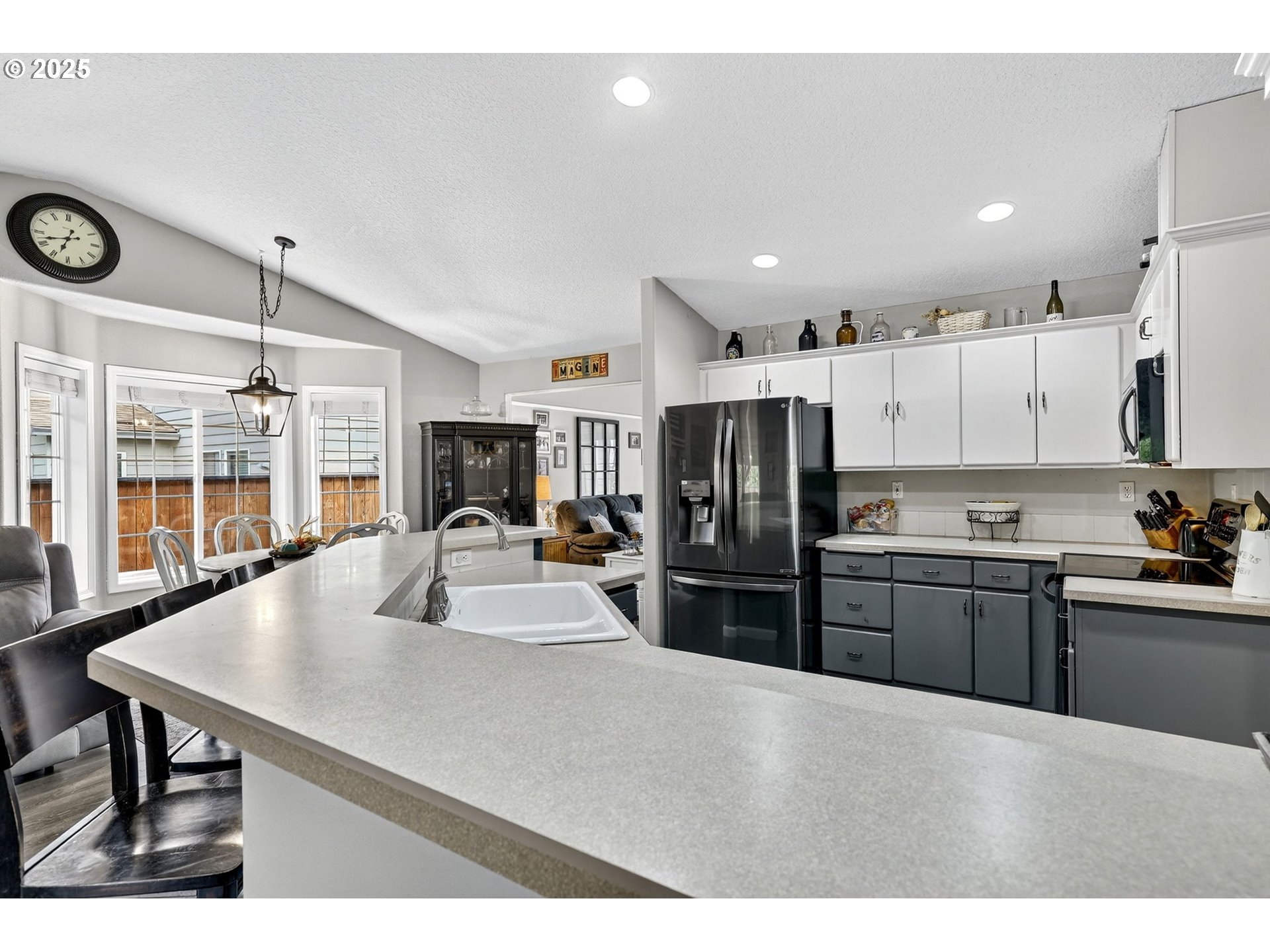 3915 Southeast 14th Street Gresham, OR 97080 - Photo 15 of 46 a kitchen with stainless steel appliances kitchen island granite countertop a refrigerator a stove a sink dishwasher and white cabinets with wooden floor