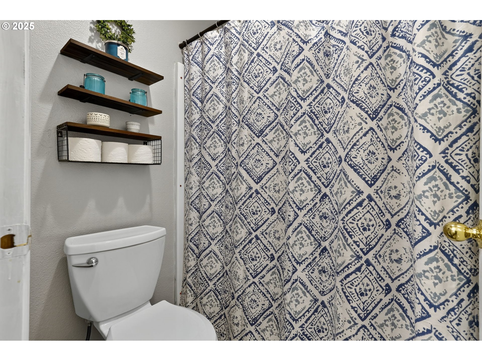 3915 Southeast 14th Street Gresham, OR 97080 - Photo 22 of 46 a bathroom with a toilet and a shower curtain