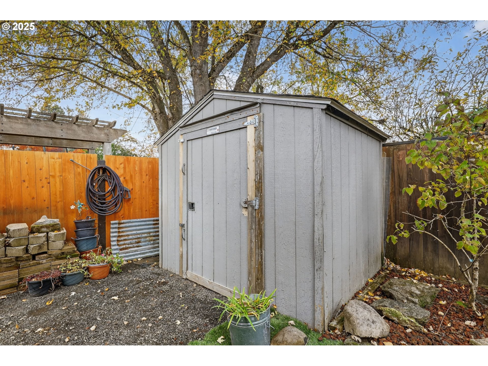 3915 Southeast 14th Street Gresham, OR 97080 - Photo 45 of 46 a backyard of a house with wooden fence and large trees