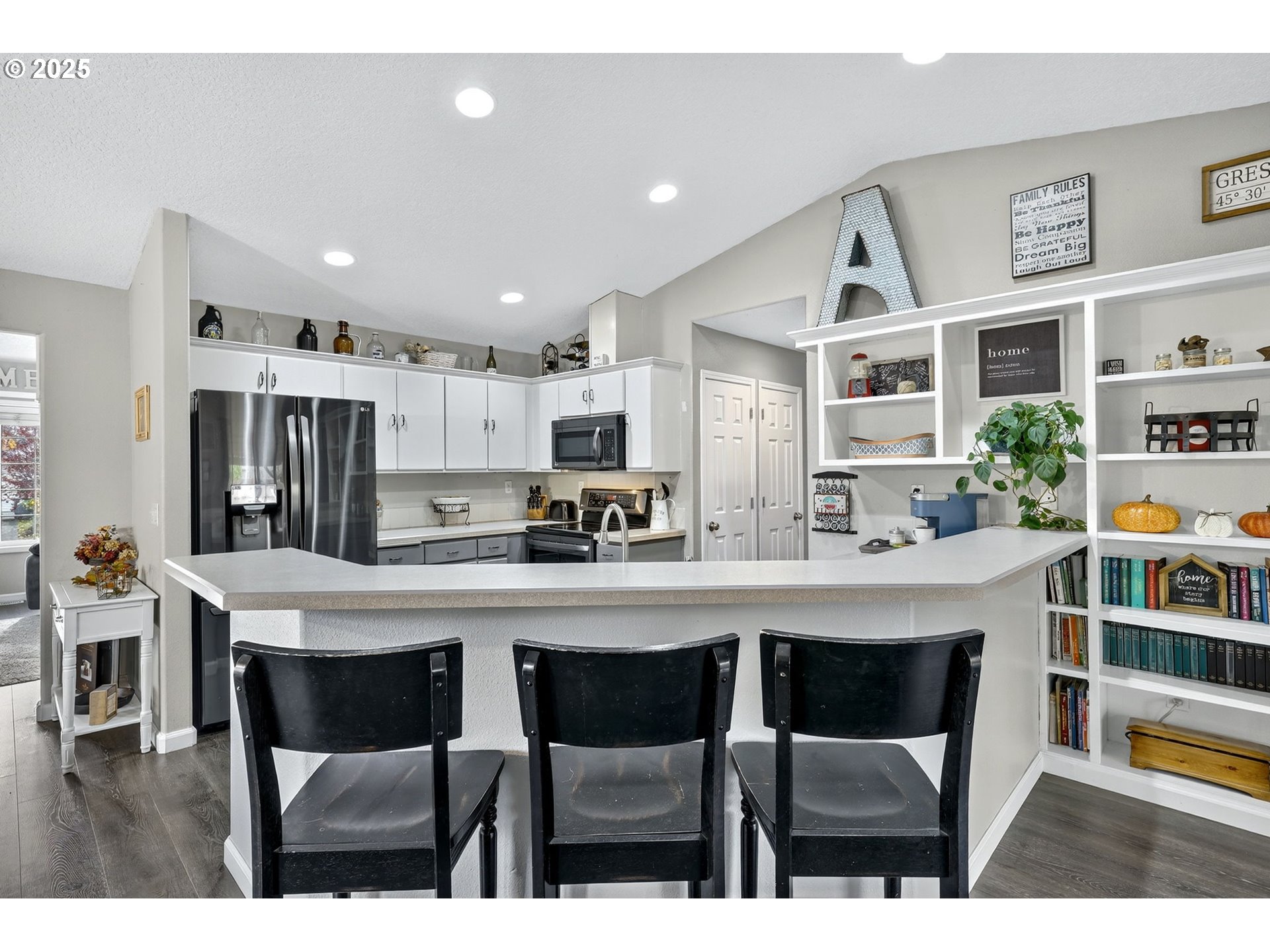 3915 Southeast 14th Street Gresham, OR 97080 - Photo 6 of 46 a kitchen with stainless steel appliances a dining table chairs and a refrigerator