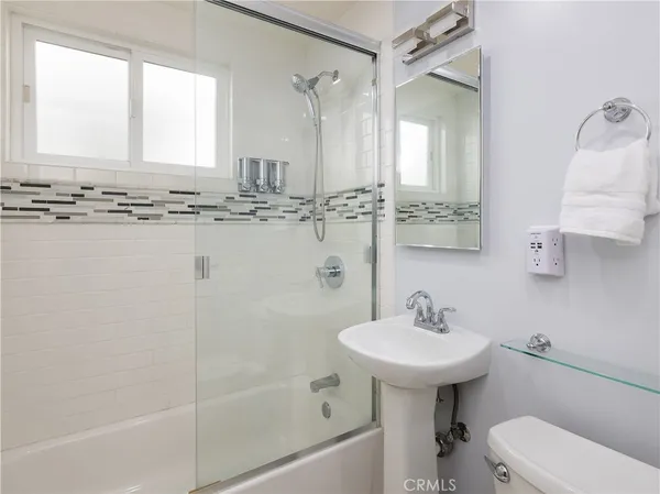 a bathroom with a sink a toilet and bathtub