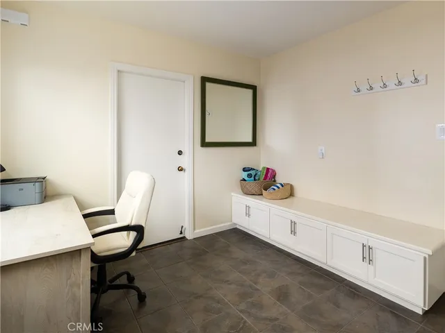 a workspace with a desk chair and painted walls