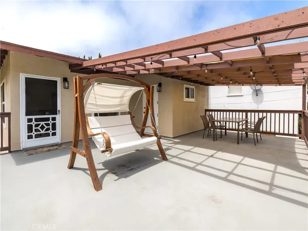 a view of a porch with a table and chairs