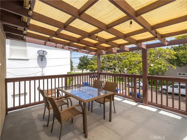 a view of a porch with furniture and a yard