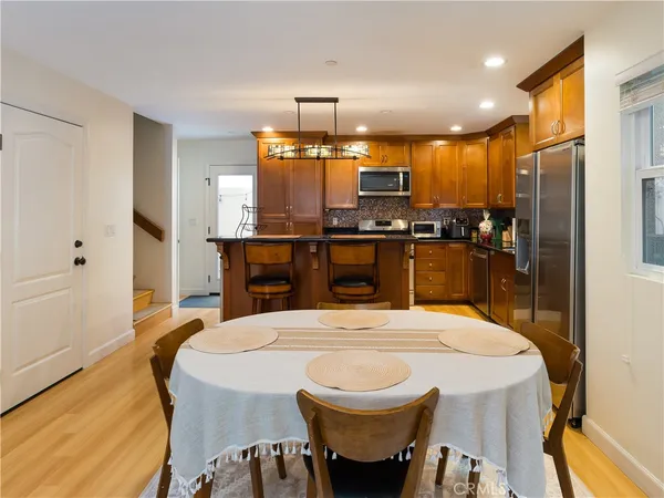 a kitchen with stainless steel appliances a sink stove and refrigerator