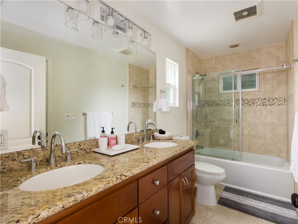 955 Virginia Street El Segundo, CA 90245 - Photo 34 of 43 a bathroom with a granite countertop sink a toilet and shower