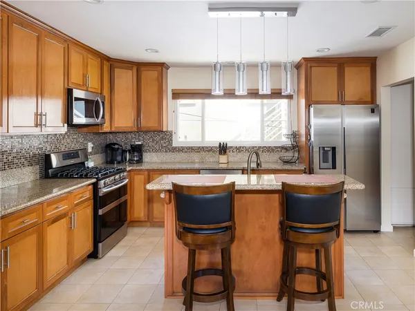 a kitchen with a sink cabinets and wooden floor