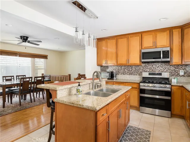 a kitchen with stainless steel appliances granite countertop a sink stove and cabinets