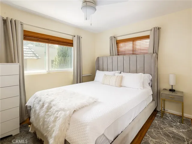 a large bed sitting in a bedroom next to a window