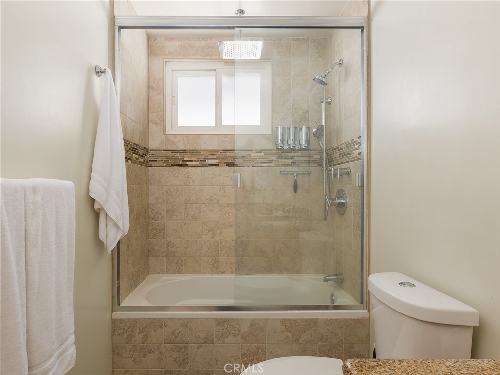 955 Virginia Street El Segundo, CA 90245 - Photo 10 of 43 a bathroom with a shower a toilet and a window