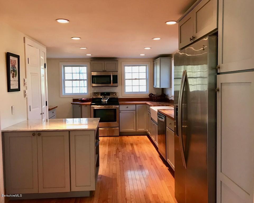 123 Frank Williams Road Shelburne, MA 01370 - Photo 8 of 30 a kitchen with stainless steel appliances granite countertop a refrigerator a sink dishwasher a stove and white cabinets with wooden floor