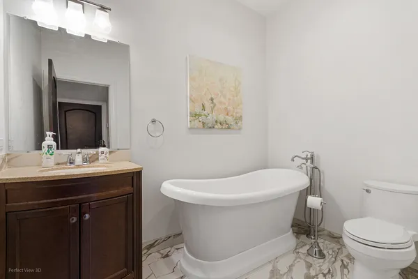 a bathroom with a toilet a sink and mirror