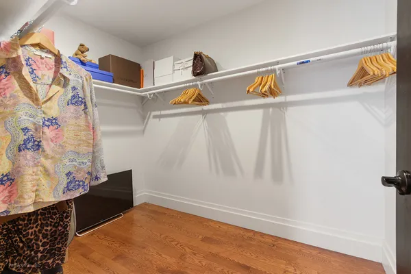 a bedroom with a bed window and a dresser