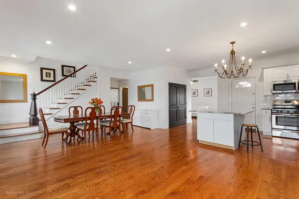 a view of a dining room with furniture and wooden floor