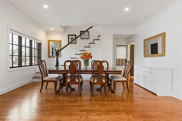 a dining room with furniture entryway and wooden floor