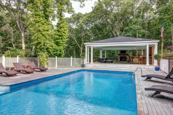 a view of house with yard outdoor seating and floor