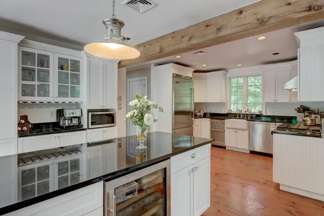 a kitchen with granite countertop stainless steel appliances and white cabinets