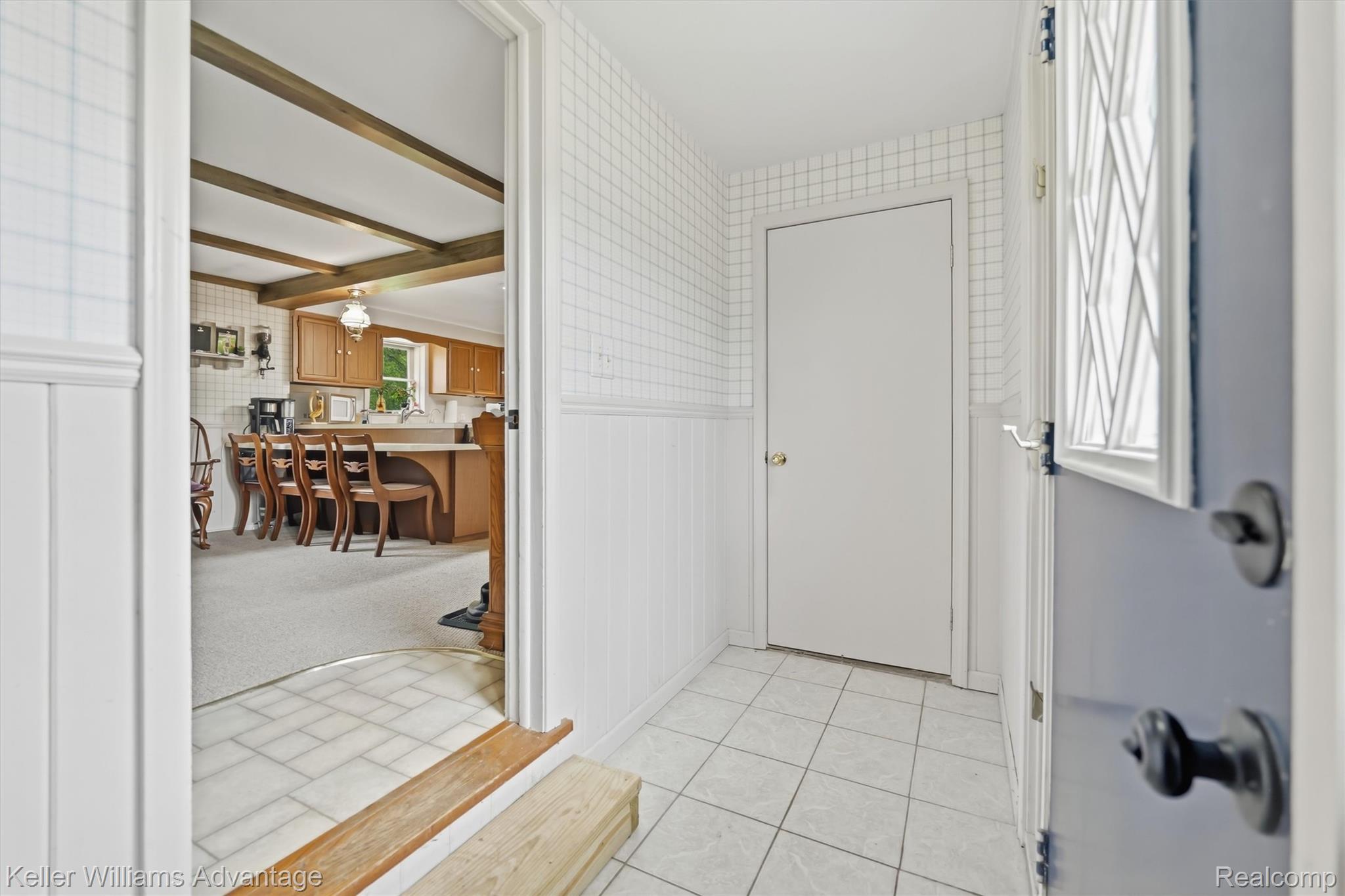 6595 Bray Road Vassar, MI 48768 - Photo 33 of 64 Entryway featuring wallpapered walls, a wainscoted wall, and beamed ceiling