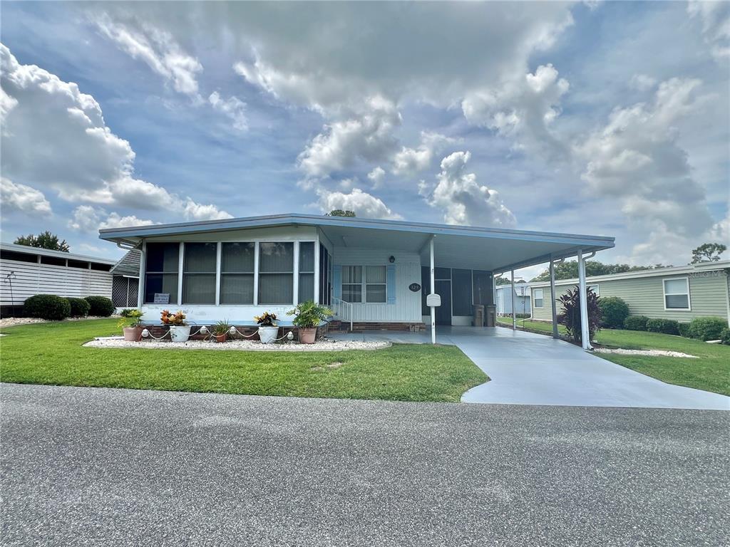 129 Hibiscus Way Leesburg, FL 34748 - Photo 1 of 1 a front view of house with yard outdoor seating and barbeque oven