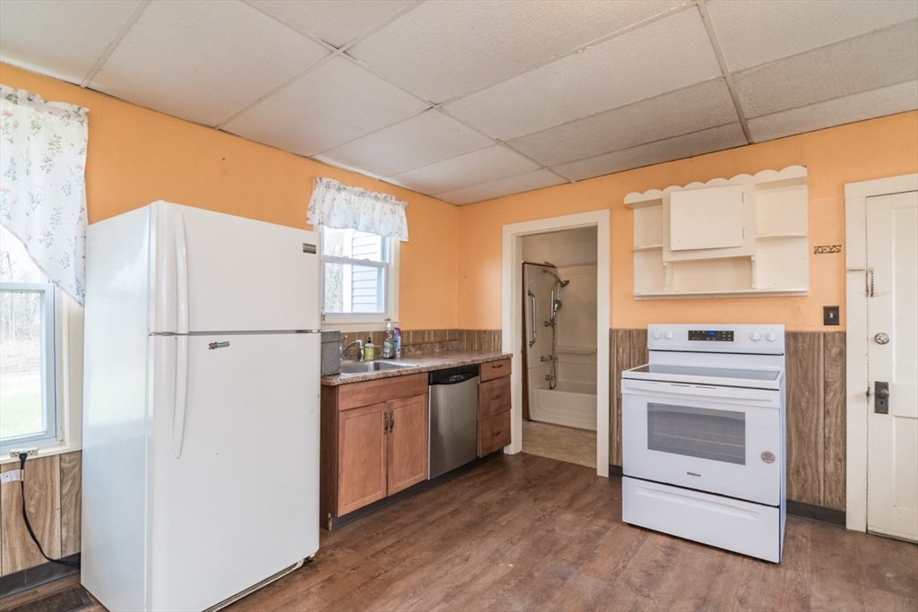 464 Main Road Gill, MA 01354 - Photo 11 of 41 a kitchen with stainless steel appliances granite countertop a refrigerator and a stove