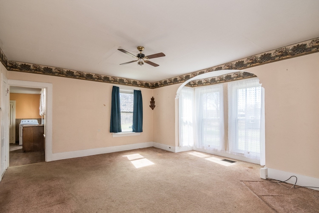 464 Main Road Gill, MA 01354 - Photo 12 of 41 a view of a livingroom with a ceiling fan and window