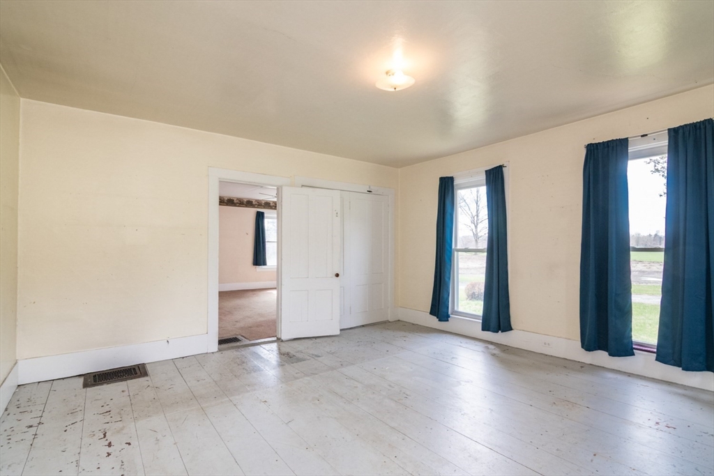 464 Main Road Gill, MA 01354 - Photo 14 of 41 an empty room with wooden floor and windows