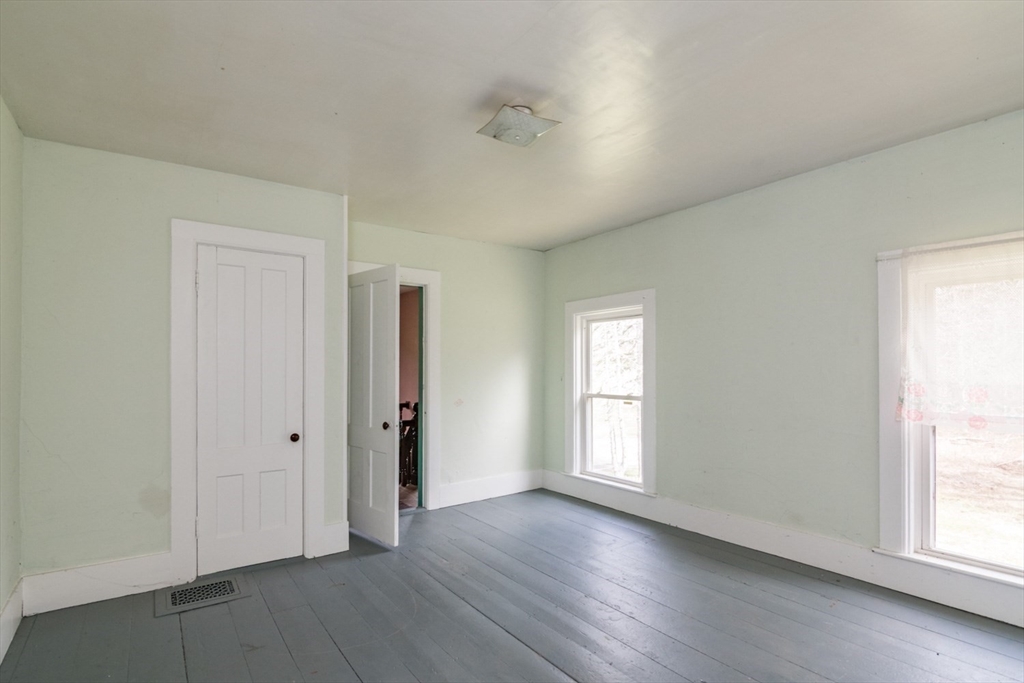 464 Main Road Gill, MA 01354 - Photo 19 of 41 an empty room with wooden floor and windows