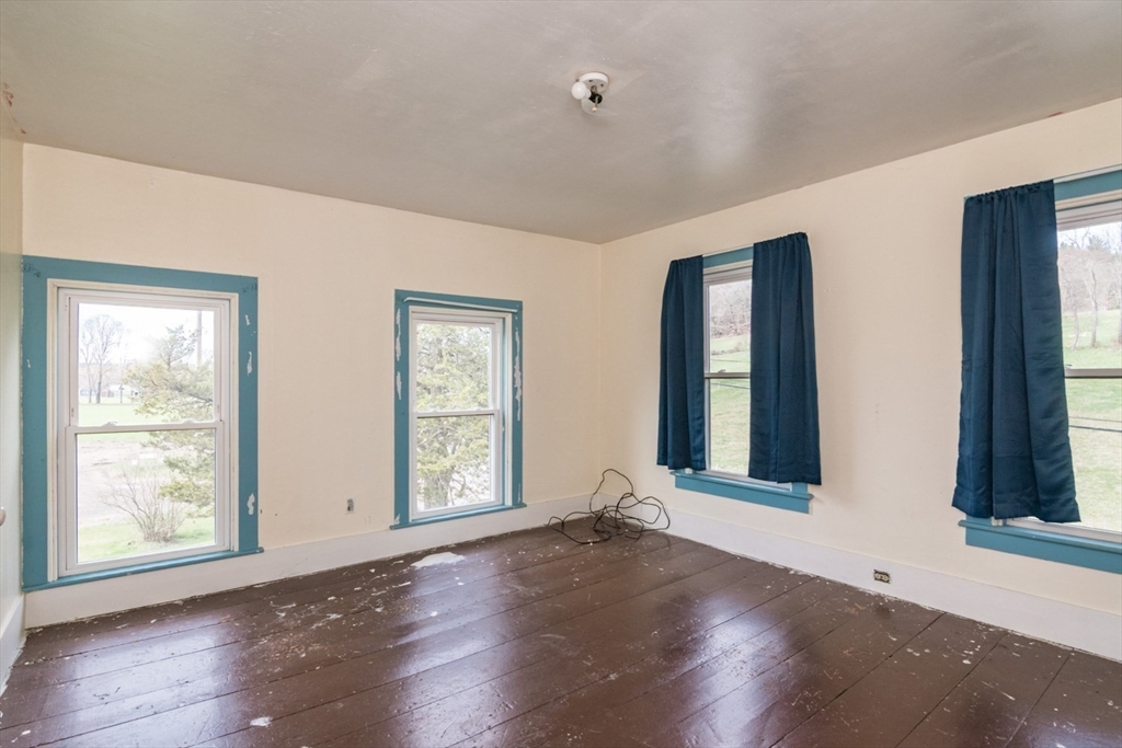 464 Main Road Gill, MA 01354 - Photo 26 of 41 a view of an empty room with wooden floor and a window