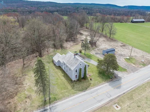 an aerial view of a house with a yard