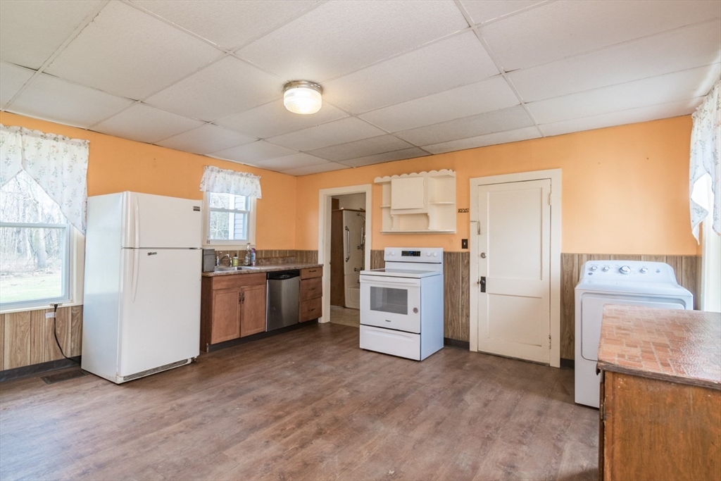 464 Main Road Gill, MA 01354 - Photo 7 of 41 a kitchen with white cabinets and white appliances