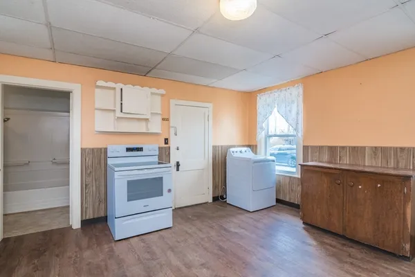 a kitchen with stainless steel appliances granite countertop a refrigerator and a stove