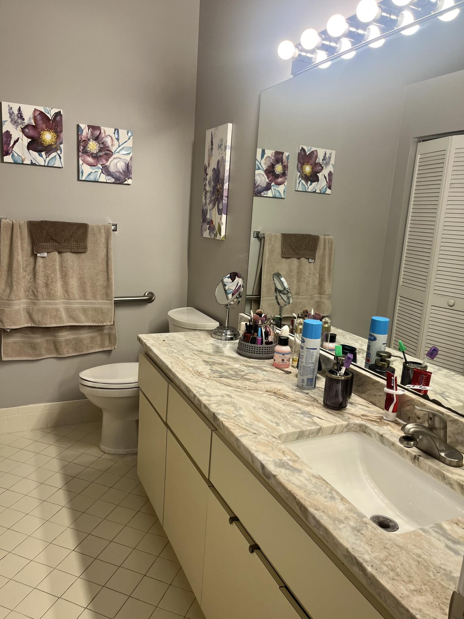 3502 Ridge Tree Court, Unit E Greenacres, FL 33463 - Photo 13 of 17 a bathroom with a granite countertop sink mirror and toilet