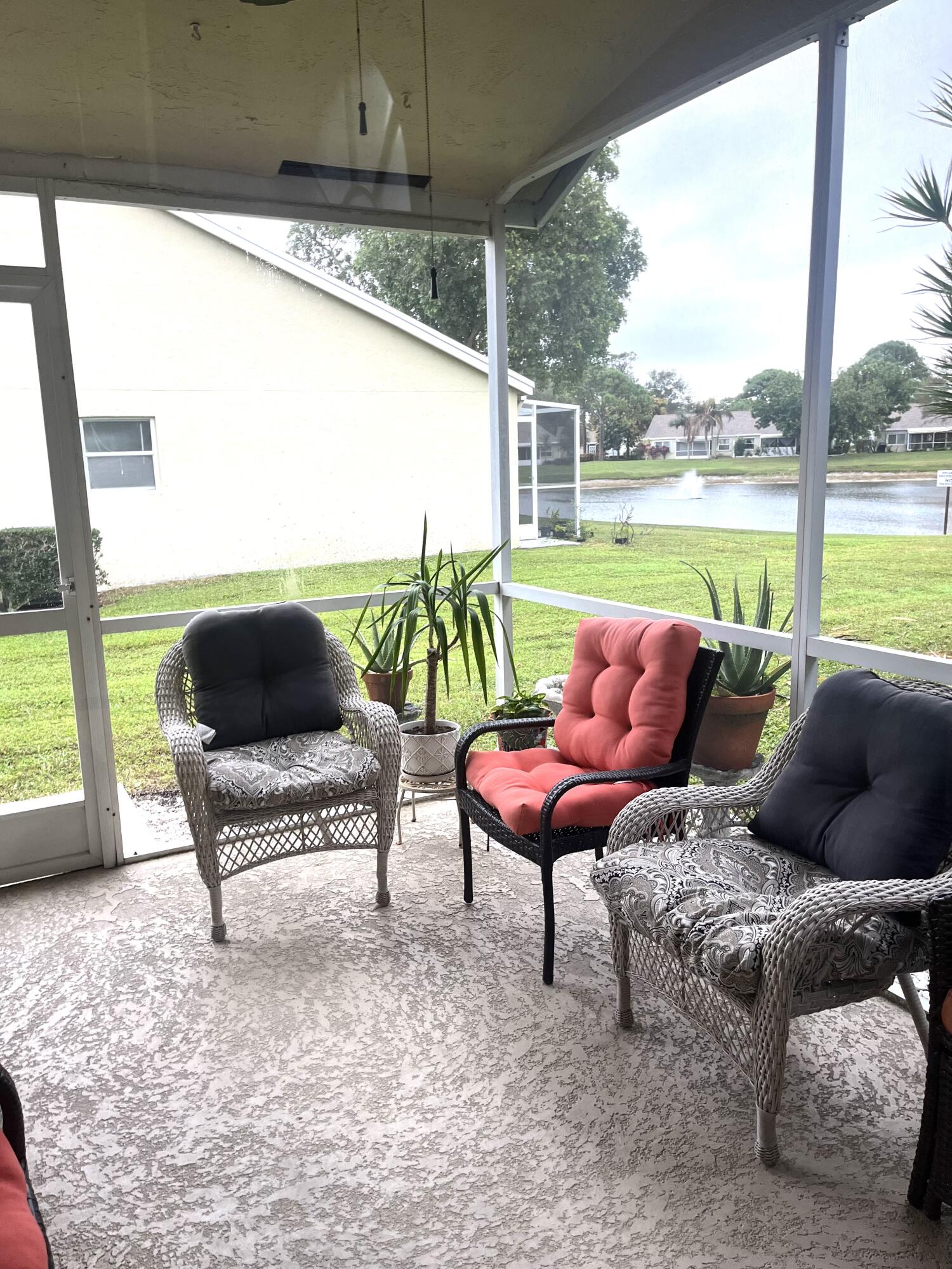 3502 Ridge Tree Court, Unit E Greenacres, FL 33463 - Photo 7 of 17 a building outdoor space with patio couch and outdoor view