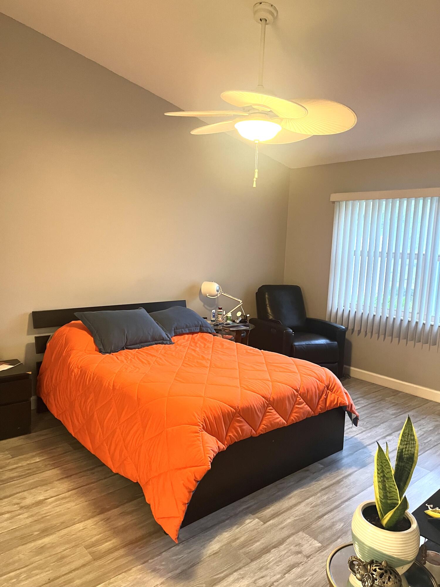 3502 Ridge Tree Court, Unit E Greenacres, FL 33463 - Photo 8 of 17 a blue bed sitting in a bedroom next to a larger window