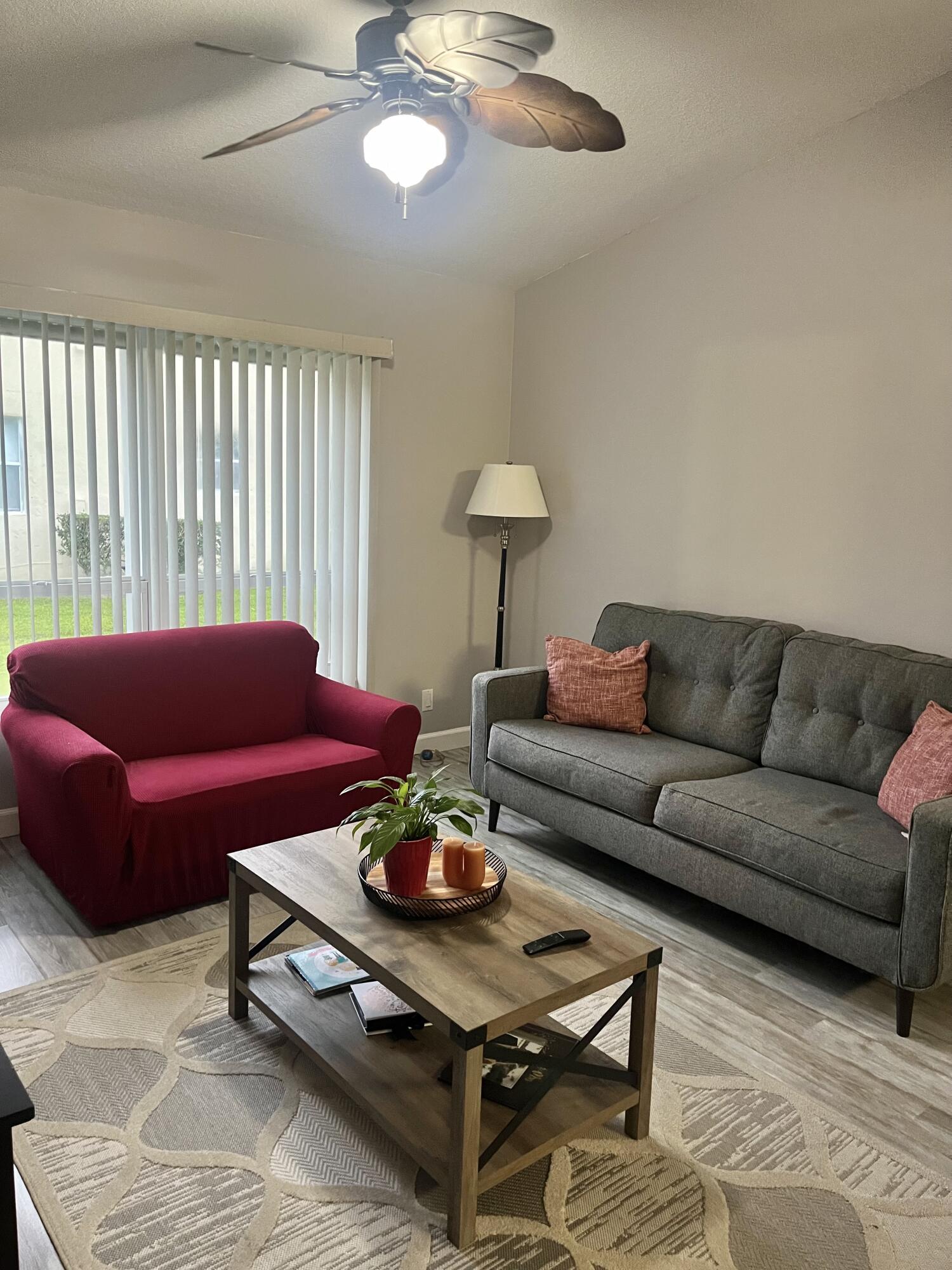 3502 Ridge Tree Court, Unit E Greenacres, FL 33463 - Photo 9 of 17 a living room with furniture a rug and a window