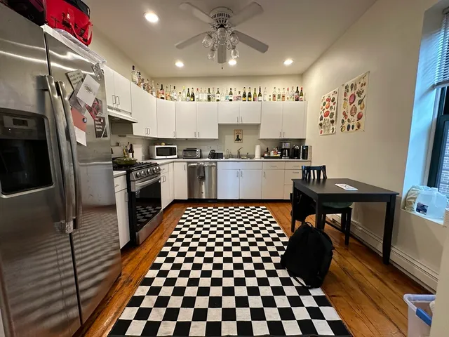 a kitchen with a sink a stove and cabinets