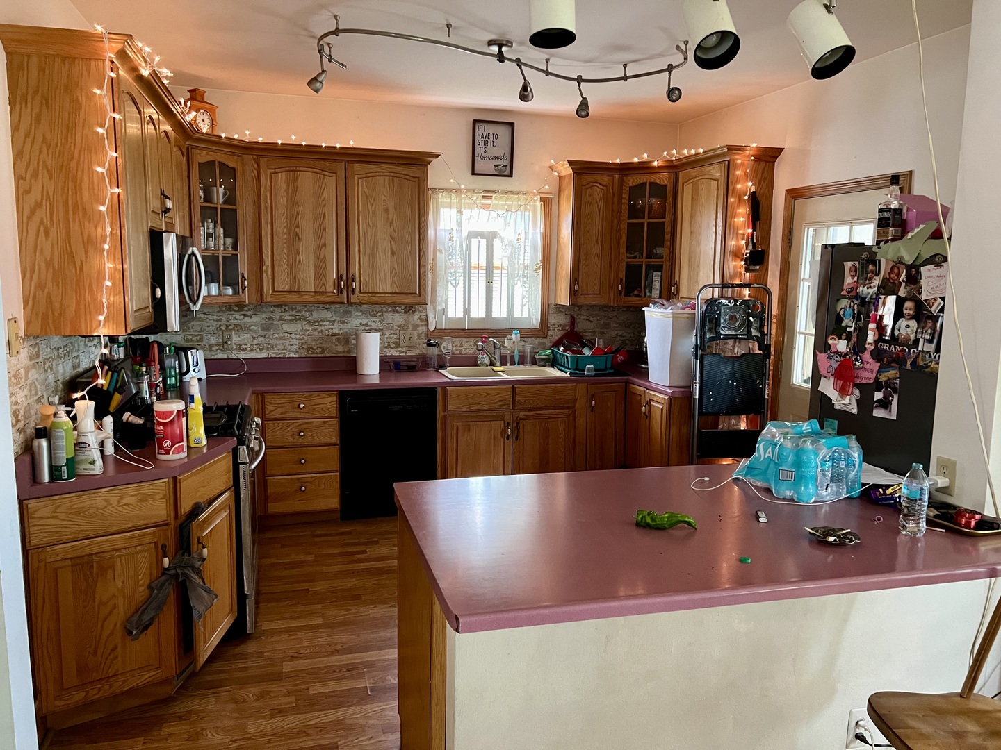 427 North 11th Street Rochelle, IL 61068 - Photo 3 of 10 a kitchen with stainless steel appliances kitchen island granite countertop a sink and cabinets