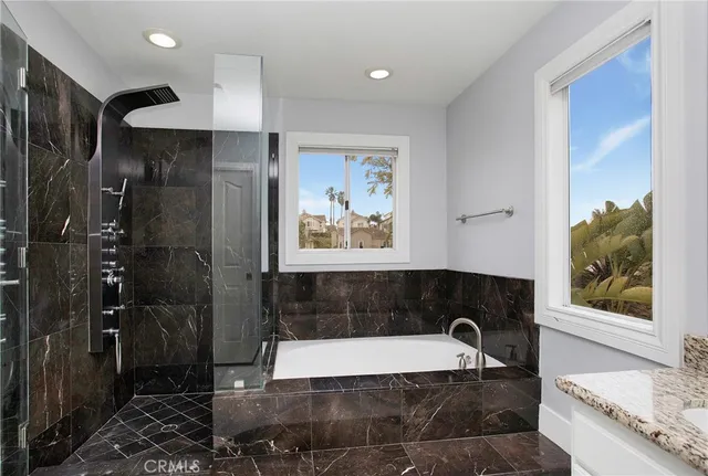 a bathroom with a bathtub and a shower