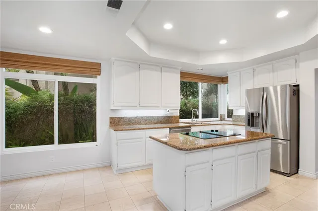a kitchen with a stove a refrigerator and a sink