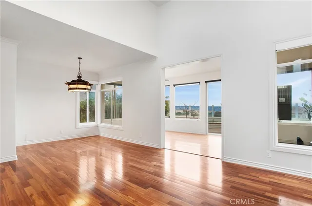 a view of a room with wooden floor and a window