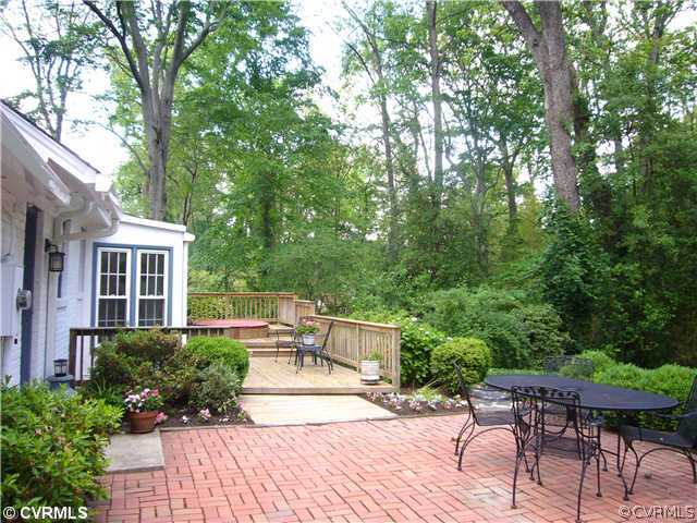 7328 Cherokee Road Richmond, VA 23225 - Photo 11 of 12 a view of a patio with table and chairs potted plants and large tree