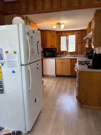 a kitchen with stainless steel appliances a refrigerator a stove a sink and a microwave