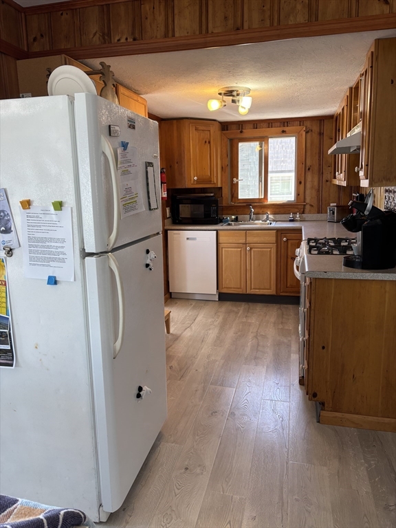 1 East Street Marshfield, MA 02050 - Photo 12 of 16 a kitchen with stainless steel appliances a refrigerator a stove a sink and a microwave