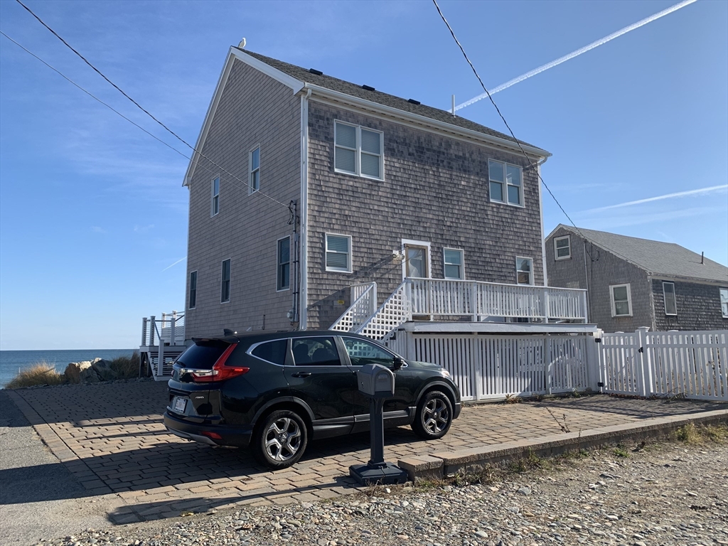 1 East Street Marshfield, MA 02050 - Photo 2 of 16 a car parked in front of a house