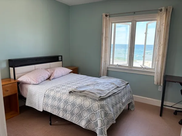 a bedroom with a bed lamp and a window
