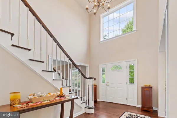a view of entryway with wooden floor and stairs